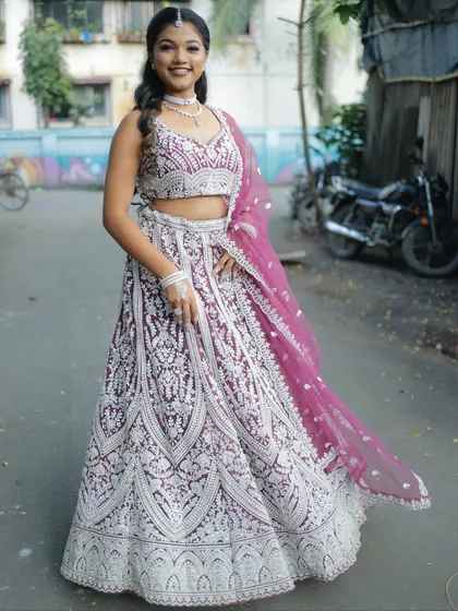 A smiling shot of this beautiful wine and silver lehenga. It's a fantastic option for an evening wedding or reception.