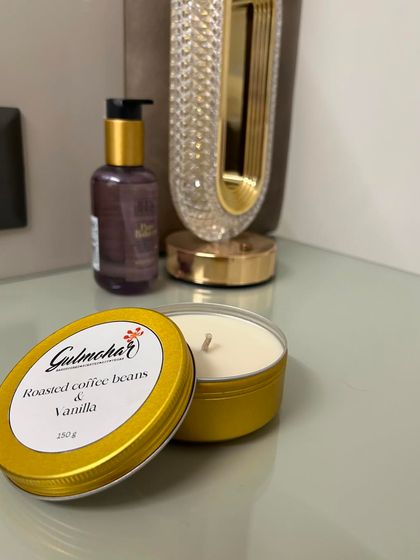 The coffee and vanilla tin candle, unlit. It's a simple, minimalist design that fits any decor.