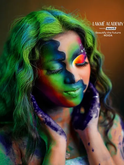 A close-up of the Holi fantasy makeup. The blend of rainbow colors on the face and hair creates a beautiful and chaotic look, perfectly capturing the spirit of Holi.