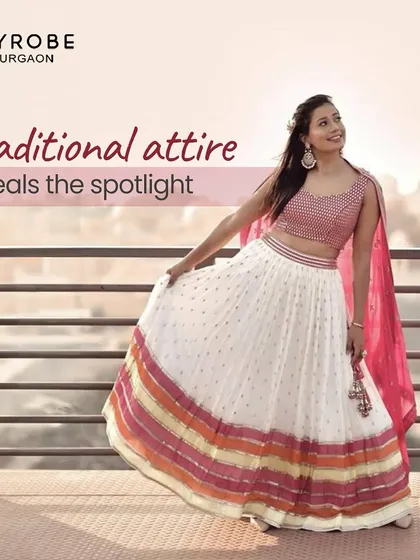 This traditional white and pink lehenga with a striped border is a classic choice for any festive occasion. It's elegant, timeless, and comfortable.