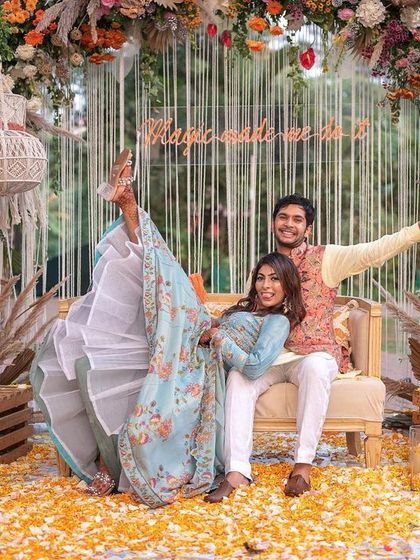 This photo is pure fun. The bride kicks up her leg with a huge smile during her bohemian-style Mehendi in Goa. It perfectly captures her vibrant personality and the joyful atmosphere of the event.