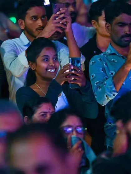 The audience at the Bengaluru Ganesh Utsava, capturing the moment on their phones. It's amazing to see how music brings people together in celebration.