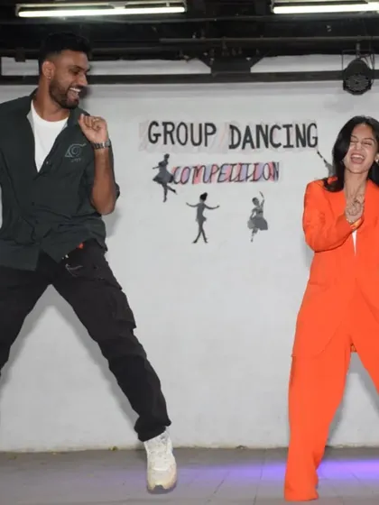 This is what we're all about. We don't just sit and judge; we live the energy of the competition. Here we are, caught in a spontaneous moment of dance during the Group Dancing Competition at St. Anne's High School, bringing our own 'josh' to the event.