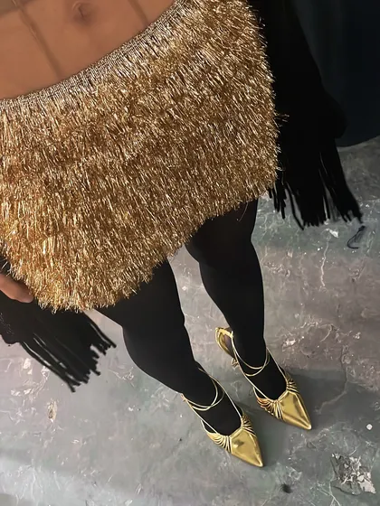 A detail shot focusing on the gold fringed skirt and matching gold shoes. This demonstrates my attention to creating a cohesive look from head to toe.