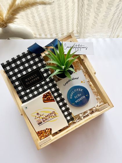 An "Employee of the Month" gift that goes beyond a digital frame. This hamper includes a weekly planner, a desk plant, and gourmet brittle, making the recognition tangible and memorable.