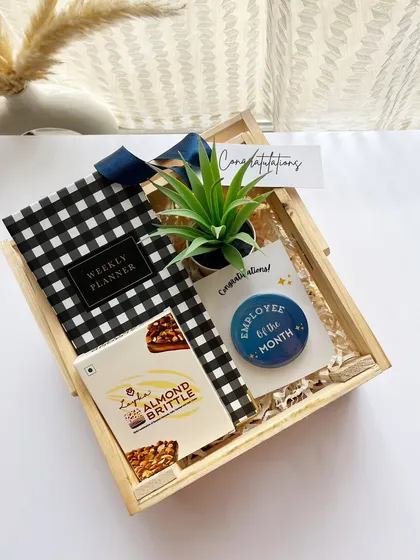 An "Employee of the Month" gift that goes beyond a digital frame. This hamper includes a weekly planner, a desk plant, and gourmet brittle, making the recognition tangible and memorable.