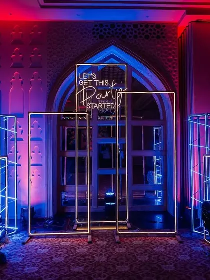 "Let's Get This Party Started!" A neon sign at the entrance of the Sangeet, setting the mood for a night of fun and dancing.