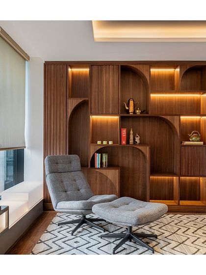 A closer look at the custom bookshelf in the wellness zone of the IHCL office. The design features integrated lighting within its arched and linear compartments, creating a warm and inviting atmosphere.