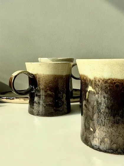 A set of our metallic bronze mugs, ready to be used. The natural ivory interior provides a beautiful contrast to the dark exterior.