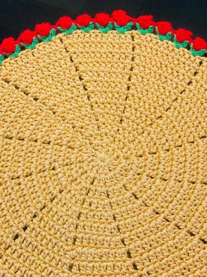 A yellow doily with a festive red tulip border. This color combination is great for celebrations.