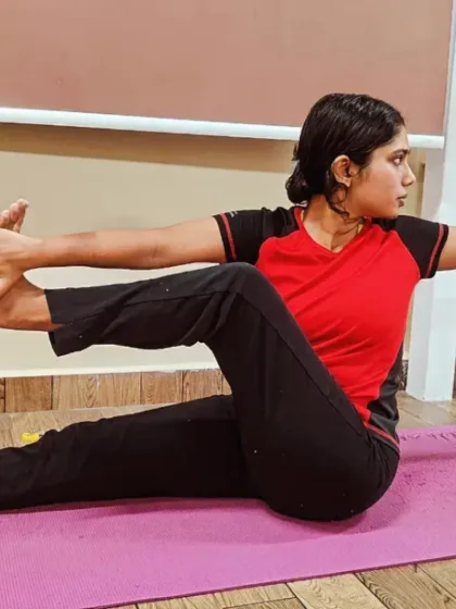 A student performs a seated spinal twist beautifully. Twisting poses are excellent for detoxifying the body, improving digestion, and maintaining a healthy spine.