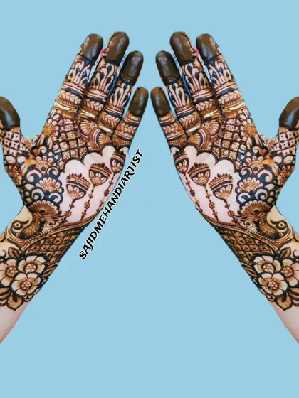 A classic, full-hand mehandi design perfect for a wedding guest. The pattern is symmetrical and packed with detail, featuring traditional floral and paisley motifs that extend up the wrist for a rich, complete look.