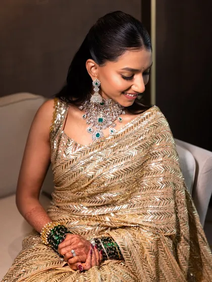 A close-up showcasing the beautiful makeup and how it complements the stunning diamond and emerald jewelry.