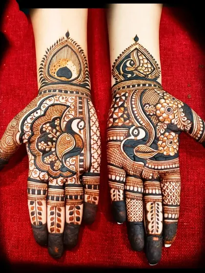 A beautiful peacock design for the palms, with intricate details on the feathers and delicate finger work.