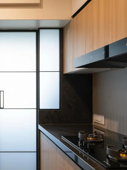 Another view of the parallel kitchen, showing the integrated hob and chimney. The design is efficient and makes the most of a narrow layout.