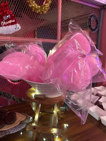 Fluffy pink cotton candy, a nostalgic favorite for all ages. It adds a touch of whimsy and fun to any party's dessert selection.