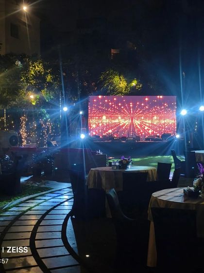 The stage and seating area for the outdoor Diwali party, with a large LED screen and ambient lighting.