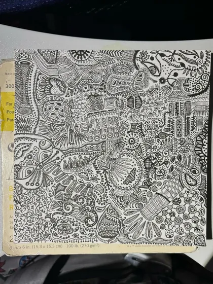 The completed drawing resting on a book. It's a journey captured on paper.