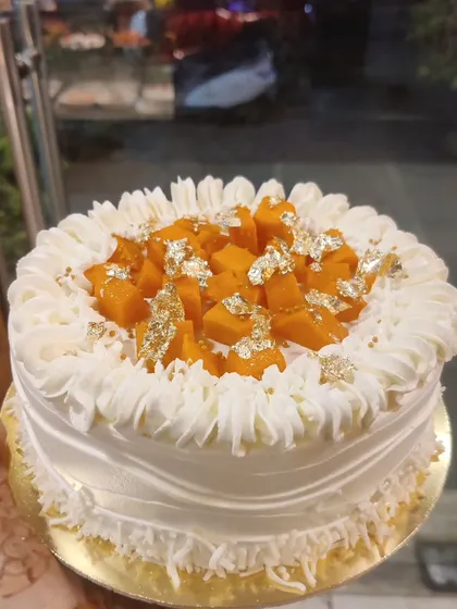 My seasonal fresh mango cake, topped with juicy mango chunks and edible gold leaf. This cake is a customer favorite during the mango season.