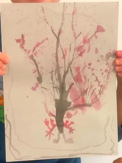 A close-up of a delicate cherry blossom tree, where ink was blown across the paper to create natural-looking branches.