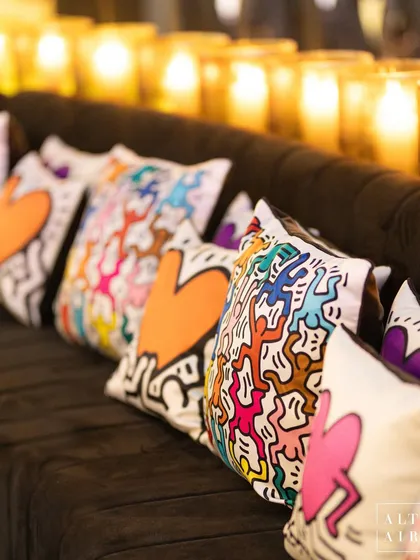 Even the soft furnishings were part of the art. These custom cushions feature Keith Haring's vibrant, dancing figures and hearts, ensuring every detail of the room was cohesive with the theme.
