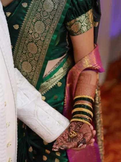 A beautiful candid shot of the couple. The bride's arm mehndi is visible, showing how the design complements her entire look.