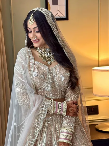The full bridal look, showcasing the beautiful pastel lehenga and the perfectly coordinated makeup. She looks like she stepped out of a fairytale.