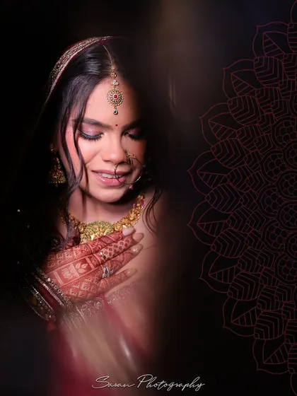 A soft, artistic portrait of the bride with her eyes closed, her hands gently resting on her chest.