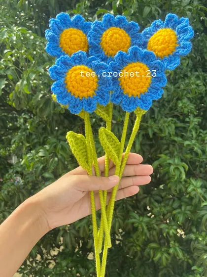 A bouquet of bright blue stuffed daisies, perfect for adding a pop of color.