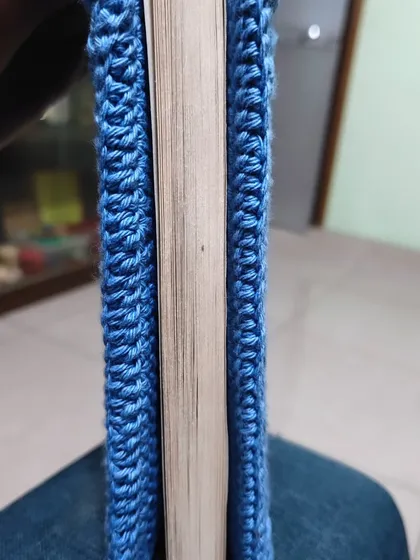 A side view of the crochet book cover, showing how neatly it fits around the book's spine and pages.