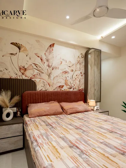 We used a large, artistic botanical wallpaper as the focal point in this bedroom. The earthy tones in the wallpaper are complemented by the rust-colored headboard and neutral bedding.