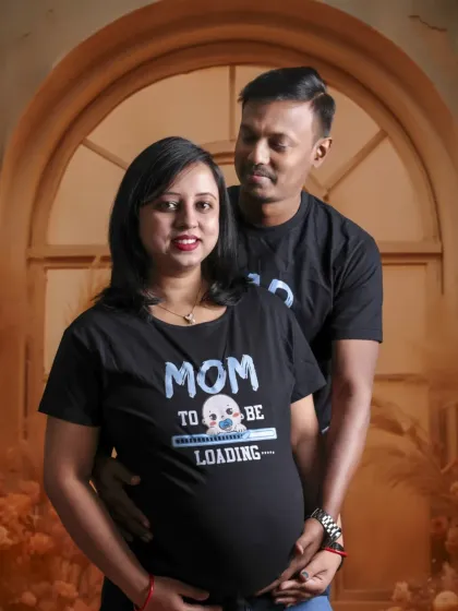A classic couple's portrait in a casual style. Their matching shirts and loving embrace make for a simple yet powerful image of their journey together.