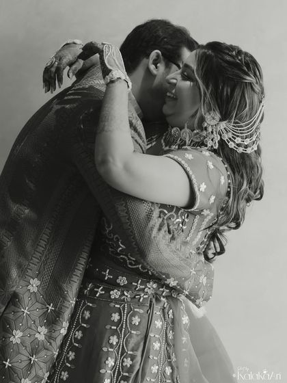A timeless black and white photo of the couple in a tight embrace, full of emotion and intimacy.