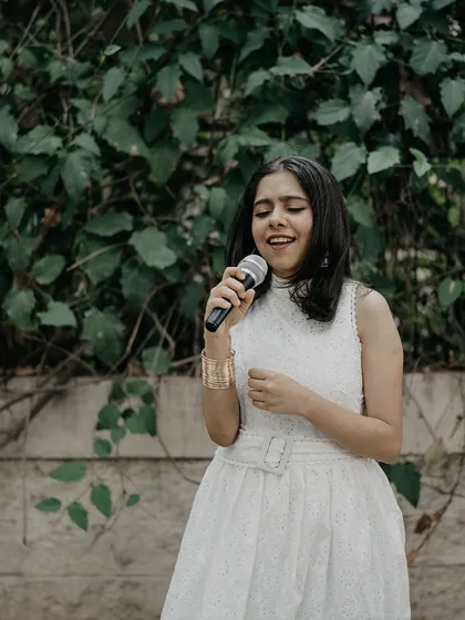 A candid moment of singing at an outdoor event. I am comfortable performing in various settings, from intimate indoor spaces to larger open-air venues.