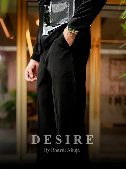 A detail shot of the black utility shirt, focusing on the texture of the fabric and the sleek, modern hardware.