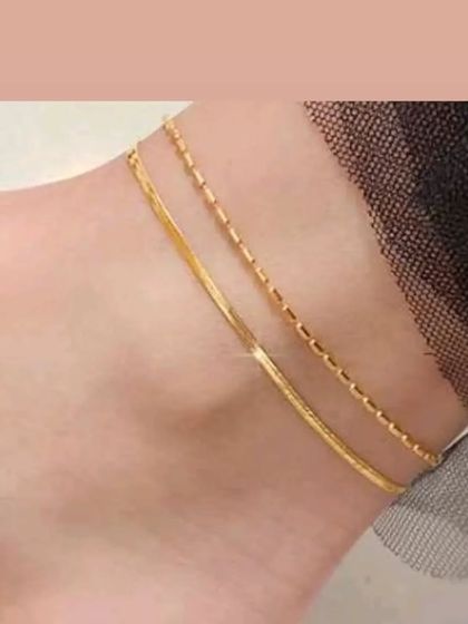 A delicate double-chain anklet, featuring one snake chain and one box chain for a textured, layered look.
