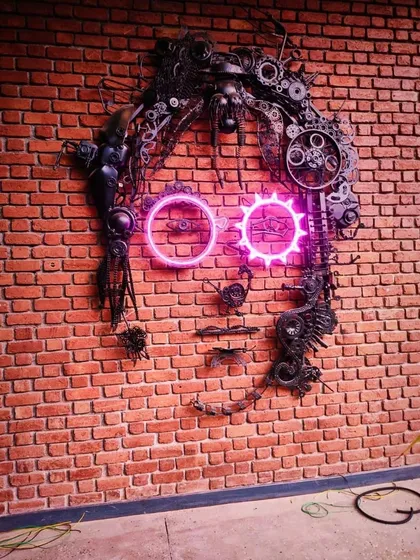 This is our tribute to a legend. We brought John Lennon to life using scrap metal, discarded gears, and custom neon lights for Street 1522 pub. This piece shows our love for turning junk into art that makes you look twice.