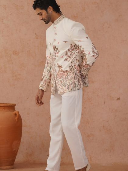 Another professional shot of the nature-inspired embroidered Jodhpuri, showing the model in motion.