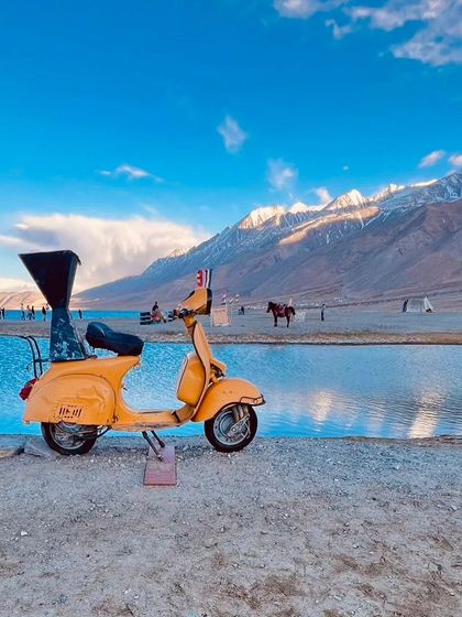 Another angle of the famous scooter at Pangong Lake, a picture-perfect memory from our Ladakh tour.