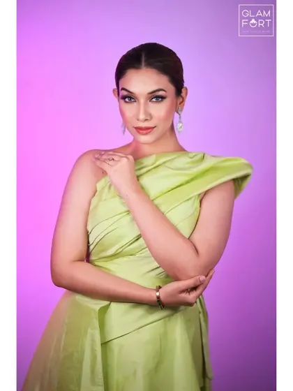 This portrait against a pink background shows how the makeup look is versatile and can be adapted for different moods and settings.