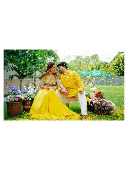 A romantic shot of the couple amidst a shower of yellow petals. This photo feels like a scene from a beautiful movie.