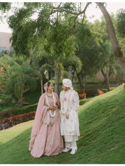 A gentle moment shared between the couple in a beautiful garden setting in Rajasthan. Their soft smiles and easy posture reflect the comfortable and deep love they share.