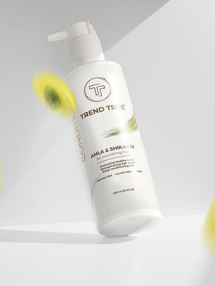 A duplicate of image 6, this dynamic shot of a floating conditioner bottle is a prime example of creative product photography that grabs attention.