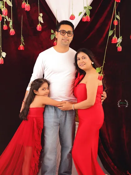 A beautiful, posed family portrait from the Valentine's session. The coordinating red outfits and romantic backdrop make this a perfect photo for a family album.