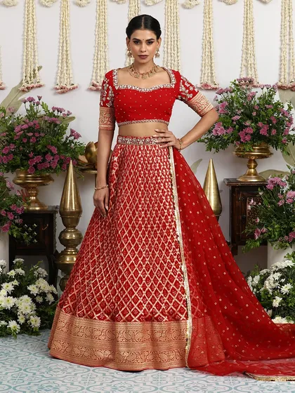 The full ensemble, with the dupatta elegantly draped, shows the complete vision of a classic Indian bride. This red and gold lehenga is a masterpiece of traditional design.