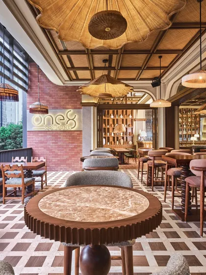 A view of the bar and seating area at One 8 Commune, showcasing our custom-fluted tabletops and checkerboard flooring that define the restaurant's modern-rustic aesthetic.