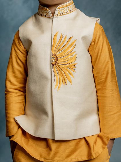 A close-up of our sunflower Bundi jacket. The unique half-flower design is a modern take on floral embroidery, making it a fun and stylish choice.