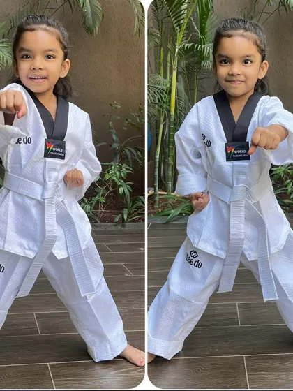 Even our youngest students learn proper form from day one. Here, a young girl demonstrates a perfect punching stance.