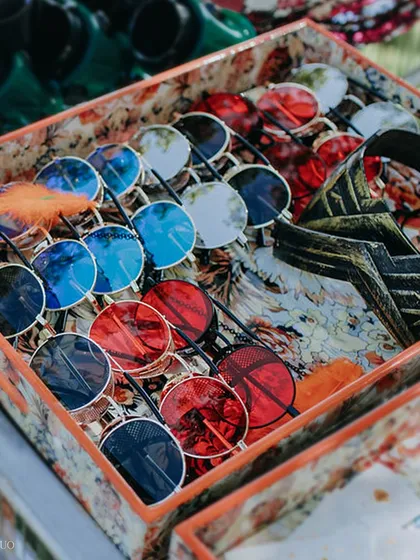 A box full of funky, colorful sunglasses, ready for guests to grab and get into the festival spirit at our "Diving with Rhe" party.