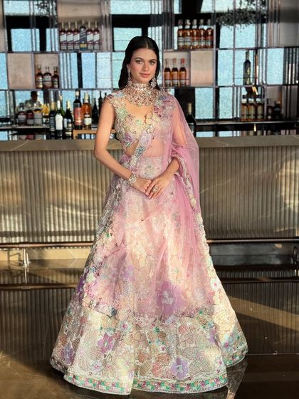 A summer-perfect bridal look in a floral pastel lehenga. The intricate color story and minimal jewelry make this a perfect moodboard addition for 2025 brides.